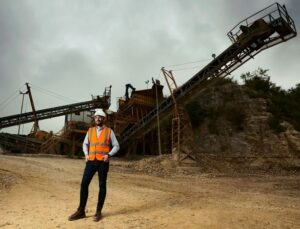 Suttles’ Director, John Suttle, in front of the stone crusher at Swanworth Quarry